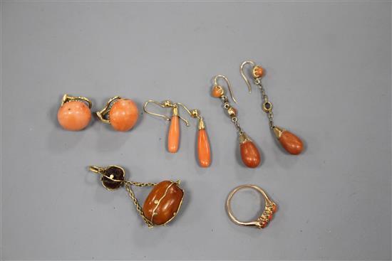 Tow pairs of yellow metal and coral drop earrings, a pair of coral ear clips, a three stone coral ring and an amber set pendant.